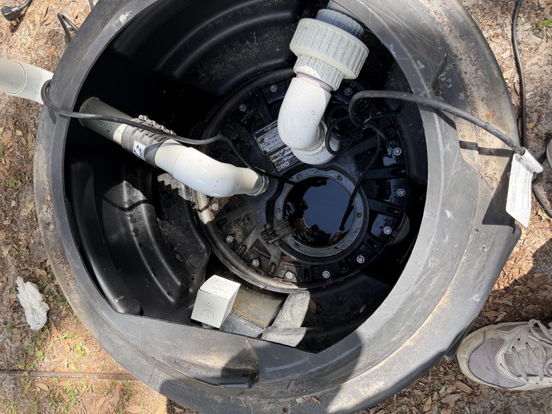 Grinder pump interior with float switches and piping connections exposed, Tampa Florida, April 2026