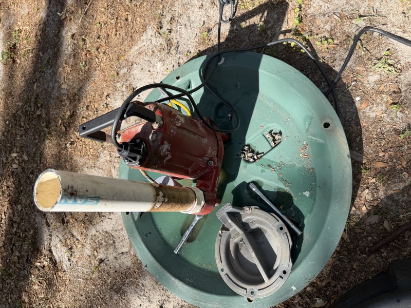 Grinder pump removed and set aside during repair and cleaning process, Tampa Florida, April 2026