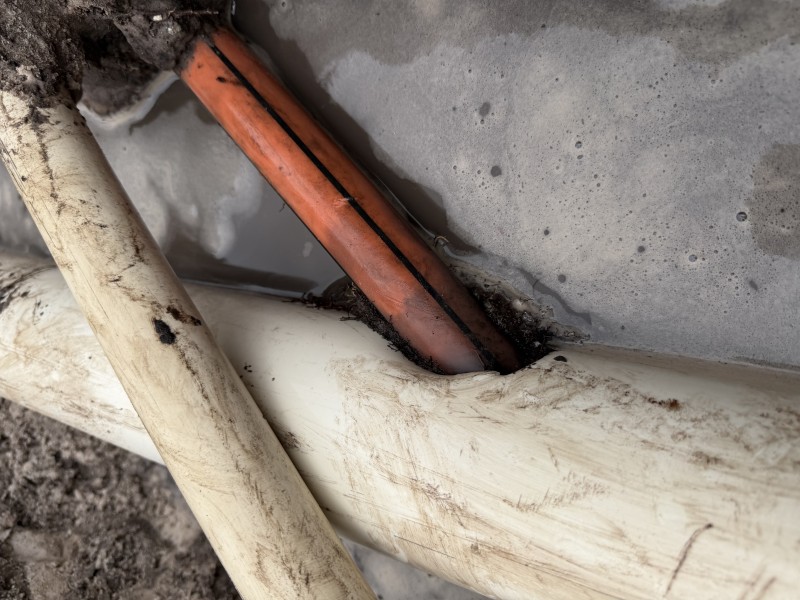 Excavation exposing underground sewer line beneath driveway in New Port Richey, Florida, May 2026